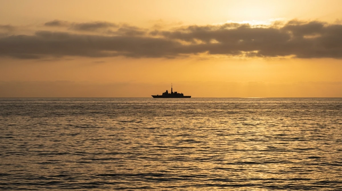 Illustration: warship silhouette on the horizon at dusk