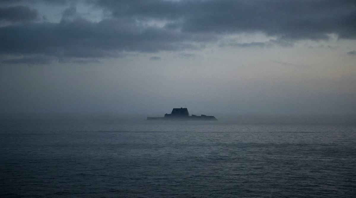 Illustration: distant stealth destroyer silhouette on an overcast sea at dusk